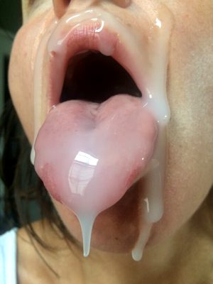 Amazing cum load facial, mouth open and tongue out, begging for more cum.