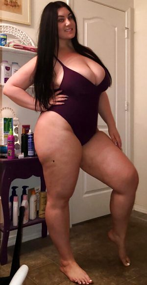 Plump Busty Amateur busting out of her tight purple one piece bikini